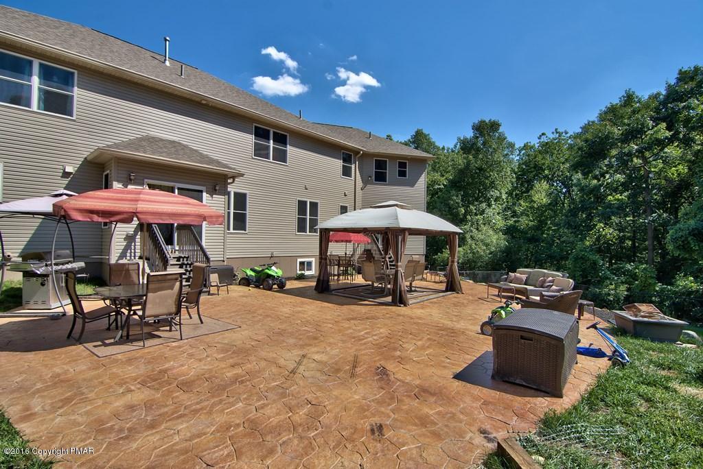 271 Williams Road Cresco, PA 18326 - Photo 31 of 46 a view of a patio with a table and chairs under an umbrella