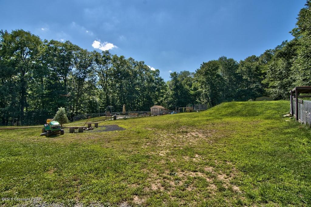271 Williams Road Cresco, PA 18326 - Photo 34 of 46 a view of a golf course with a house in the background