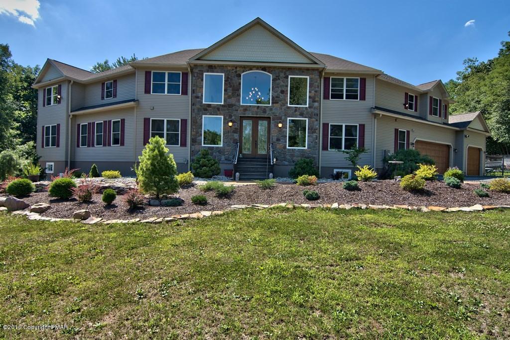 271 Williams Road Cresco, PA 18326 - Photo 46 of 46 a front view of a house with a yard table and chairs