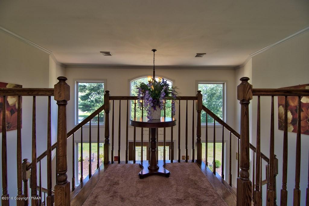 271 Williams Road Cresco, PA 18326 - Photo 6 of 46 a view of staircase with railing and a chandelier