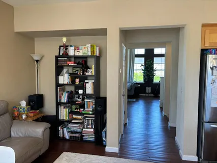 a living room with furniture and a book shelf