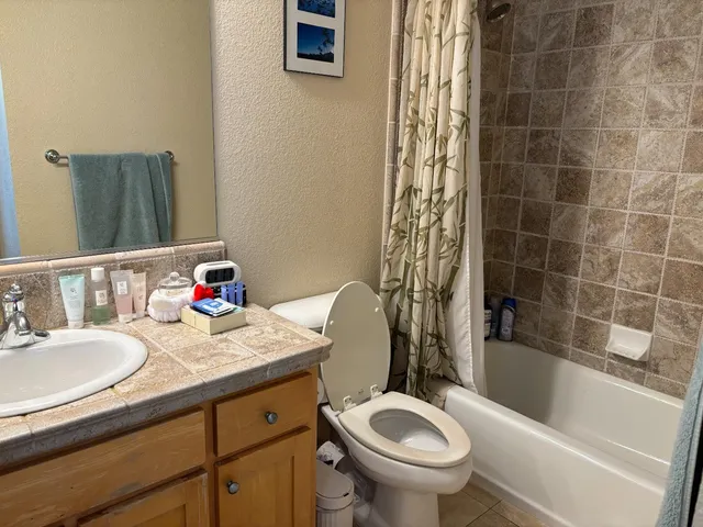 a bathroom with a sink a toilet and bathtub