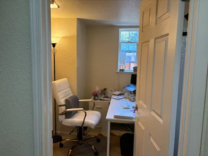 a dining room with furniture and window