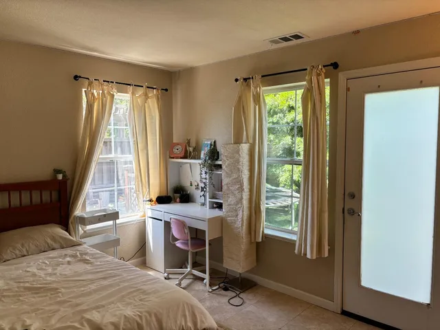 a bedroom with a bed and a window