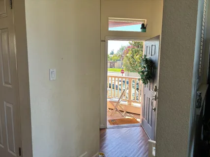 a view of an entryway with wooden floor
