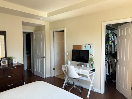 a living room with a flat screen tv and a refrigerator