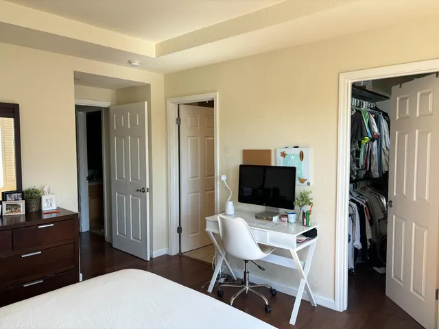 a living room with a flat screen tv and a refrigerator