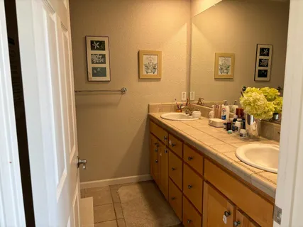 a bathroom with a double vanity sink and a mirror