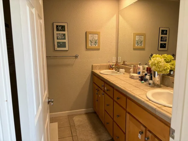 a bathroom with a double vanity sink and a mirror