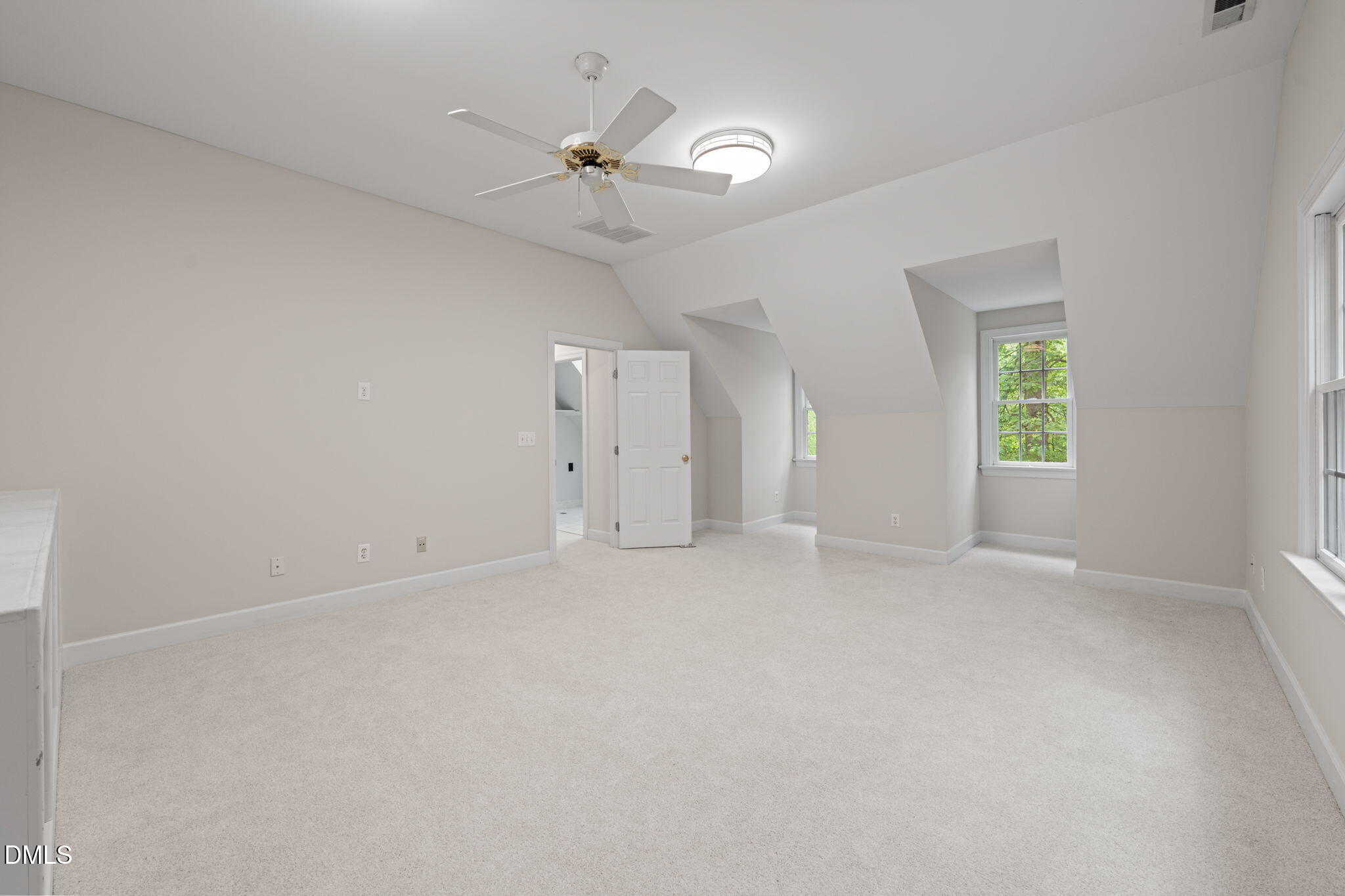 5809 Stone Spring Road Raleigh, NC 27613 - Photo 34 of 54 an empty room with windows and fan