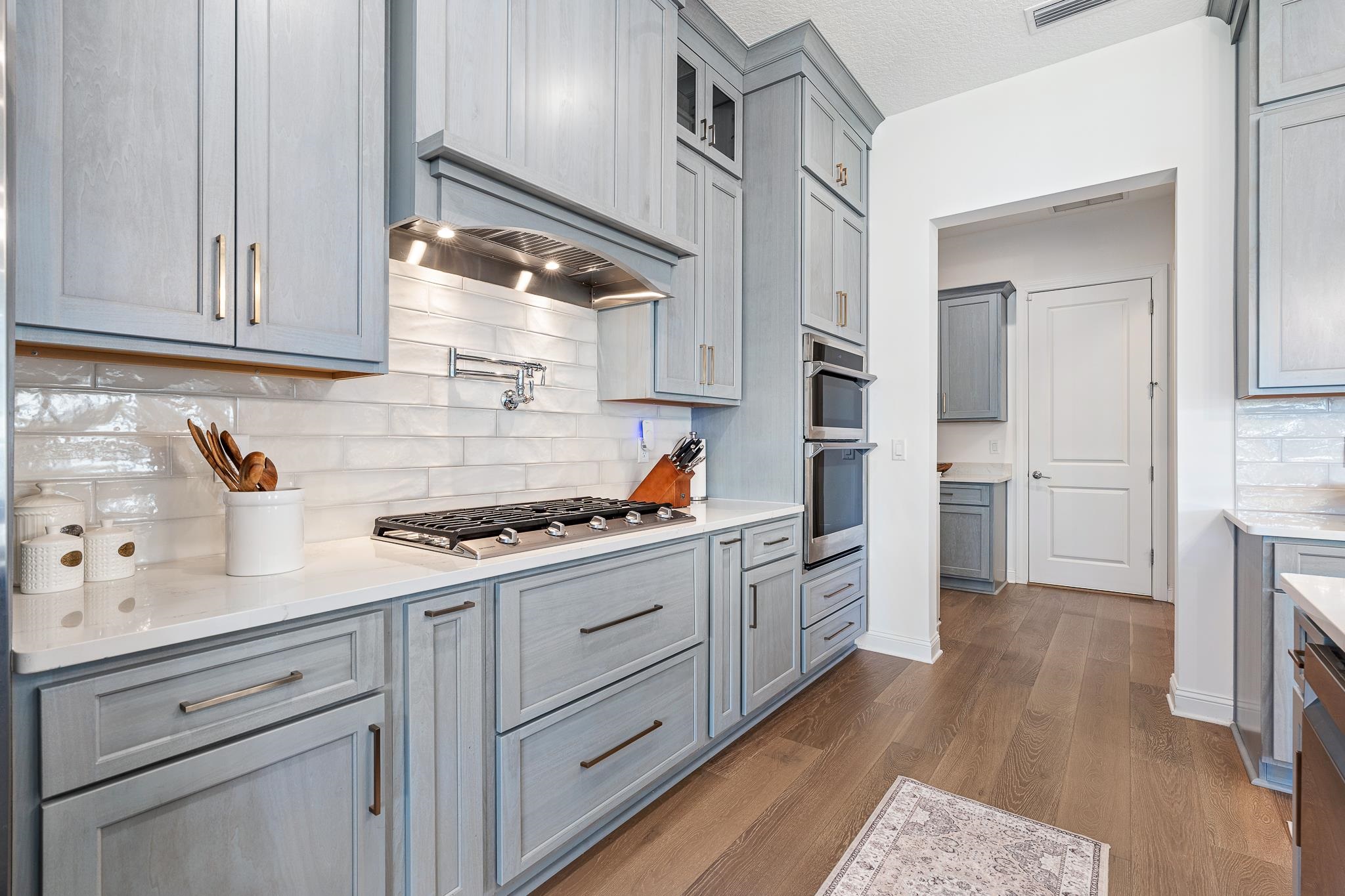 164 Tesoro Terrace St. Augustine, FL 32095 - Photo 18 of 98 a kitchen with stainless steel appliances granite countertop a stove and a refrigerator
