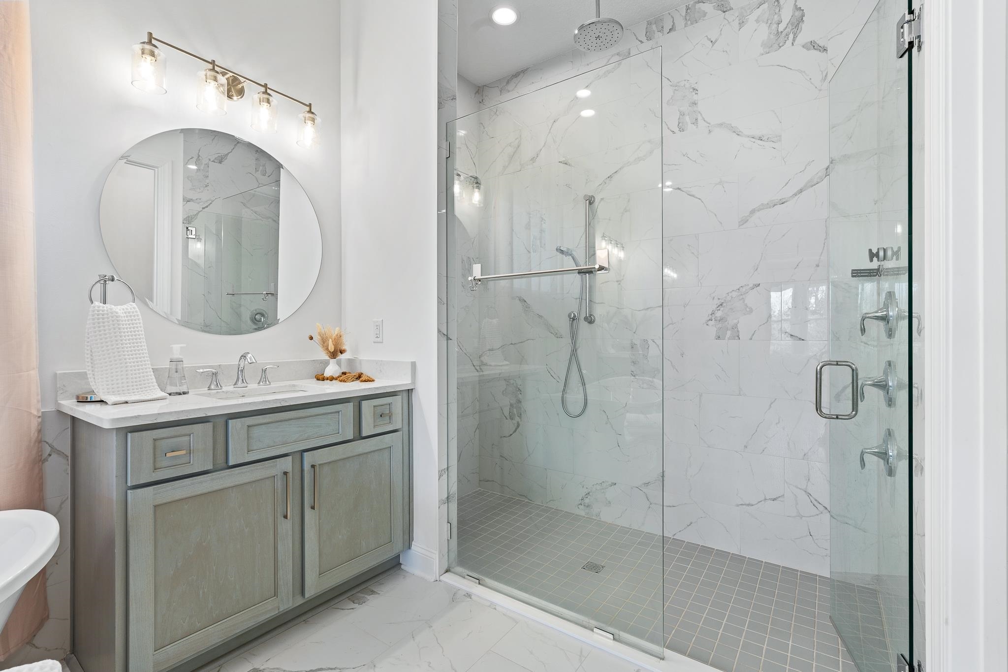 164 Tesoro Terrace St. Augustine, FL 32095 - Photo 32 of 98 a bathroom with a shower sink and mirror