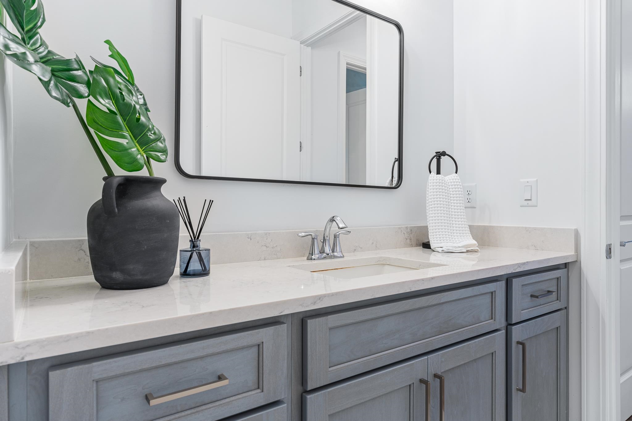 164 Tesoro Terrace St. Augustine, FL 32095 - Photo 44 of 98 a bathroom with a granite countertop sink a potted plant and a mirror