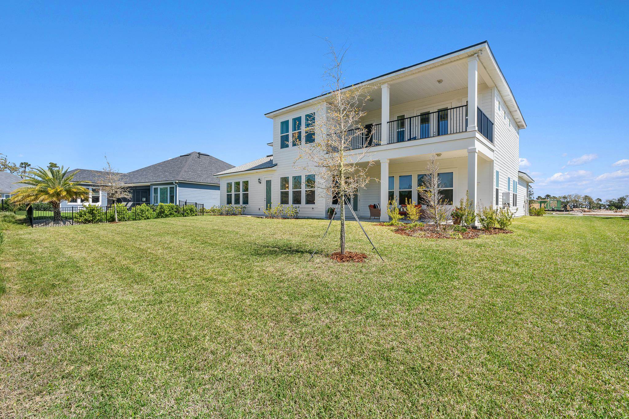 164 Tesoro Terrace St. Augustine, FL 32095 - Photo 70 of 98 a front view of a building with a garden and plants