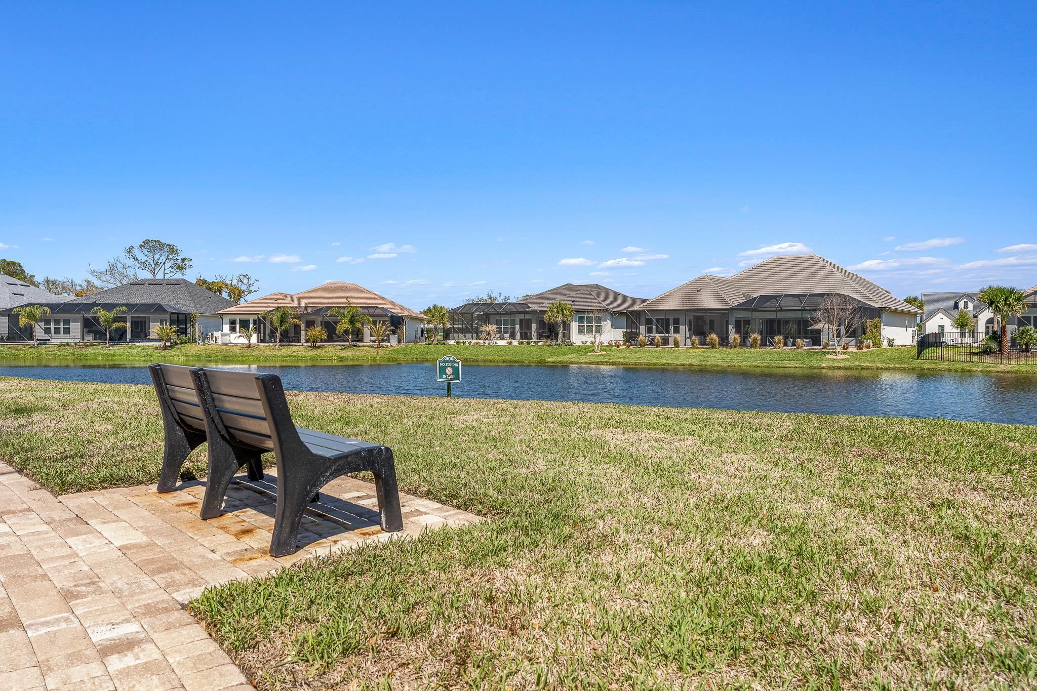 164 Tesoro Terrace St. Augustine, FL 32095 - Photo 96 of 98 a view of a lake with a table and chairs in the patio