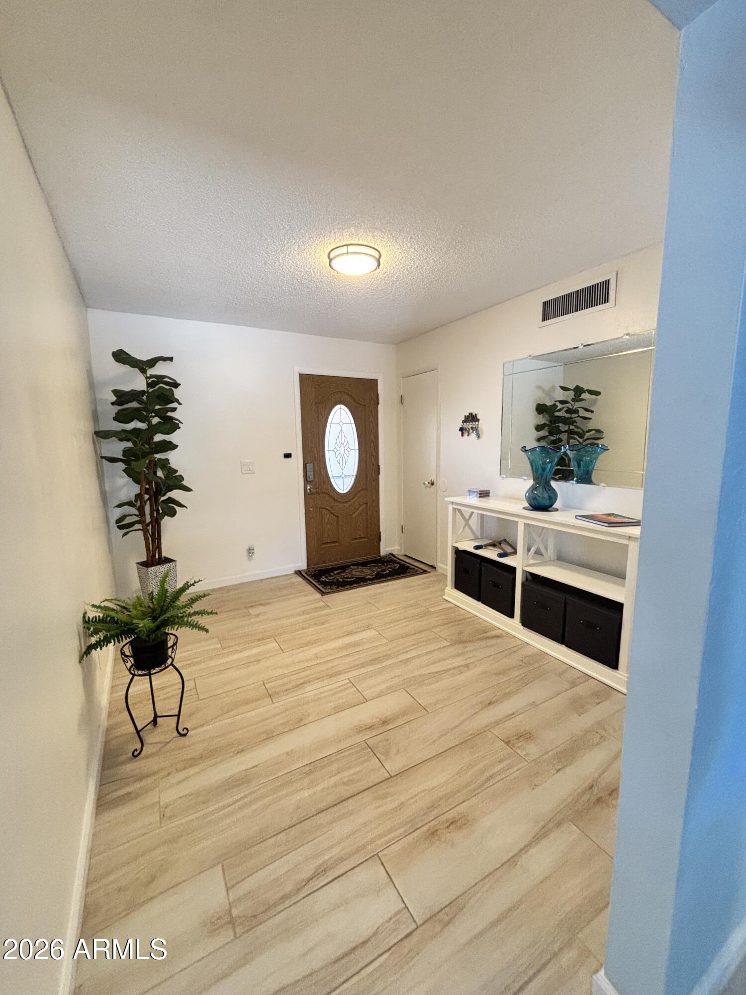 7745 East Mangun Road Mesa, AZ 85207 - Photo 18 of 35 a bedroom with a bed and a potted plant