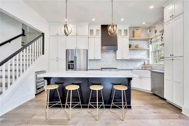 a kitchen with a table chairs refrigerator and microwave