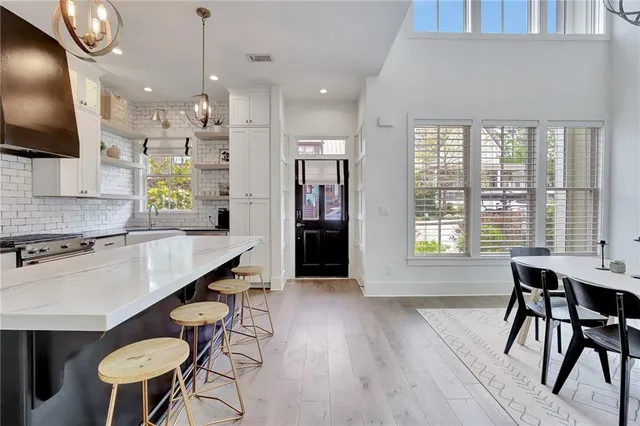 a kitchen with a table chairs sink and microwave