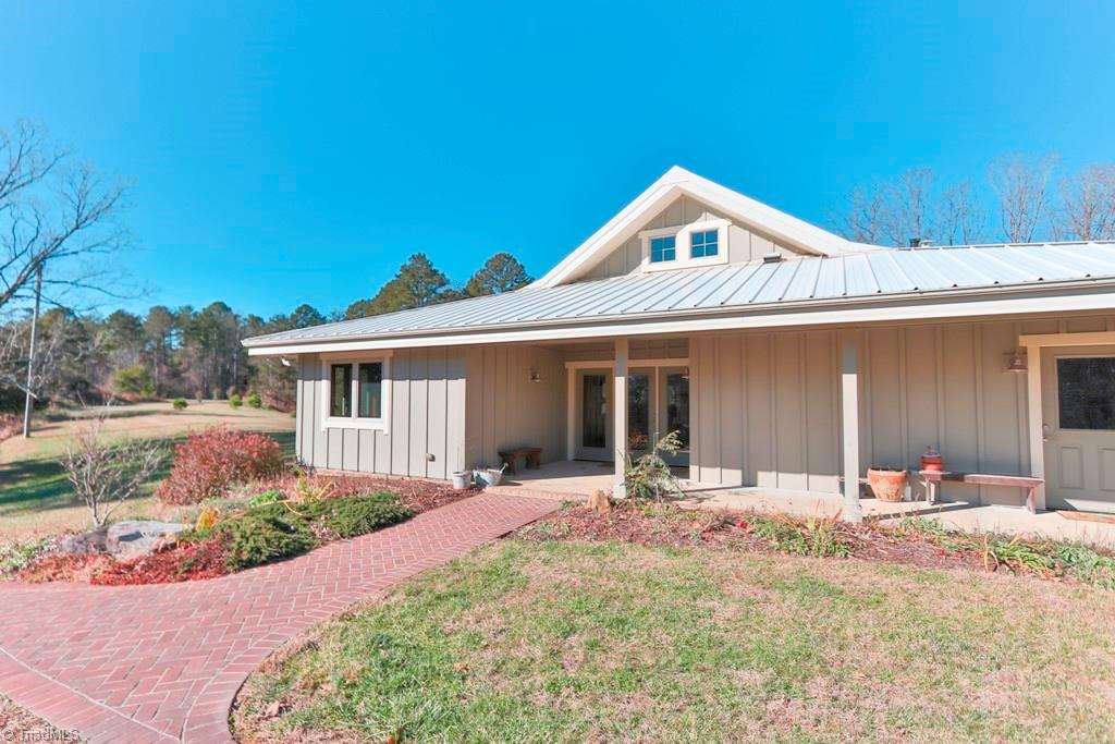 1045 West Old Phillips Road Pinnacle, NC 27043 - Photo 1 of 29 Exterior features Hardiboard siding and a metal roof. Covered entry and walkway.