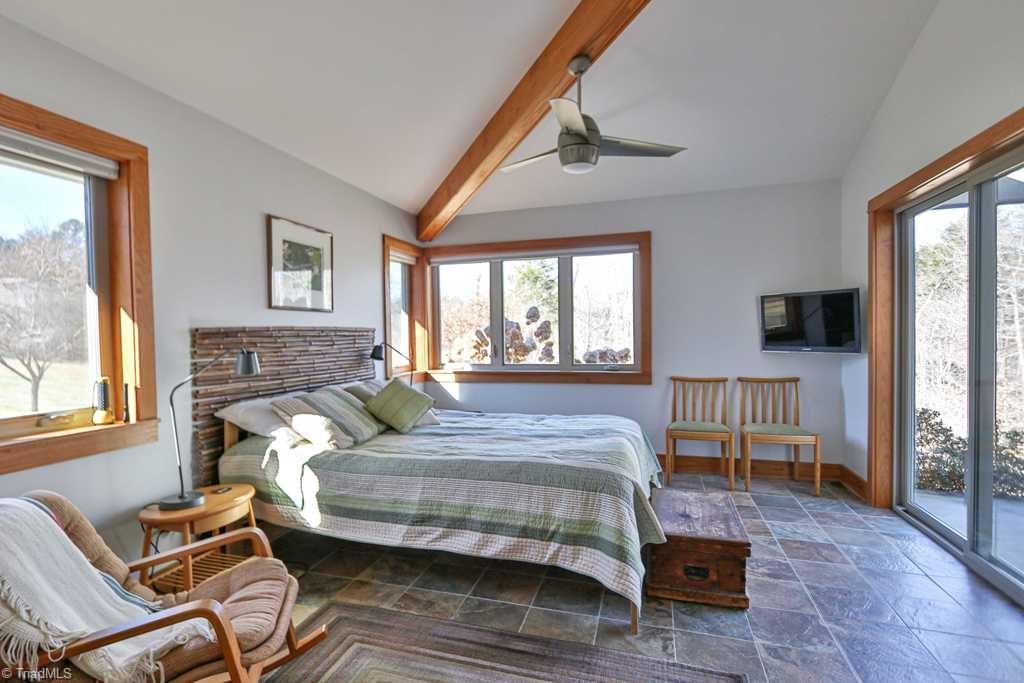 1045 West Old Phillips Road Pinnacle, NC 27043 - Photo 15 of 29 Master bedroom with vaulted ceiling, access to covered patio and lots of light.