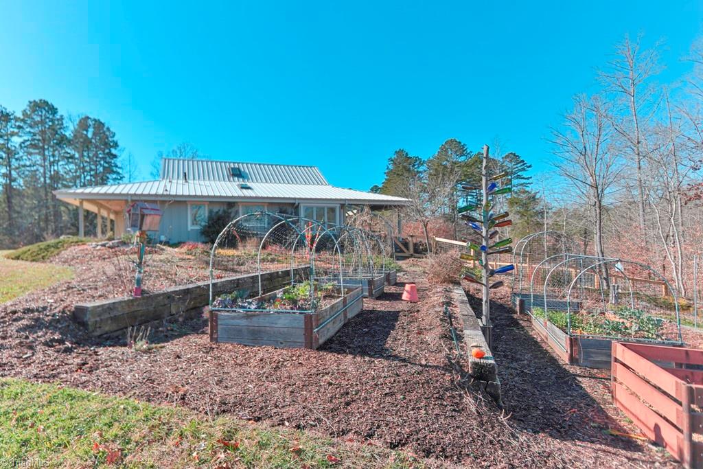 1045 West Old Phillips Road Pinnacle, NC 27043 - Photo 18 of 29 Extensive landscaping with raised garden beds, two Koi ponds and over 1000 flowering bulbs and hundreds of perennials.