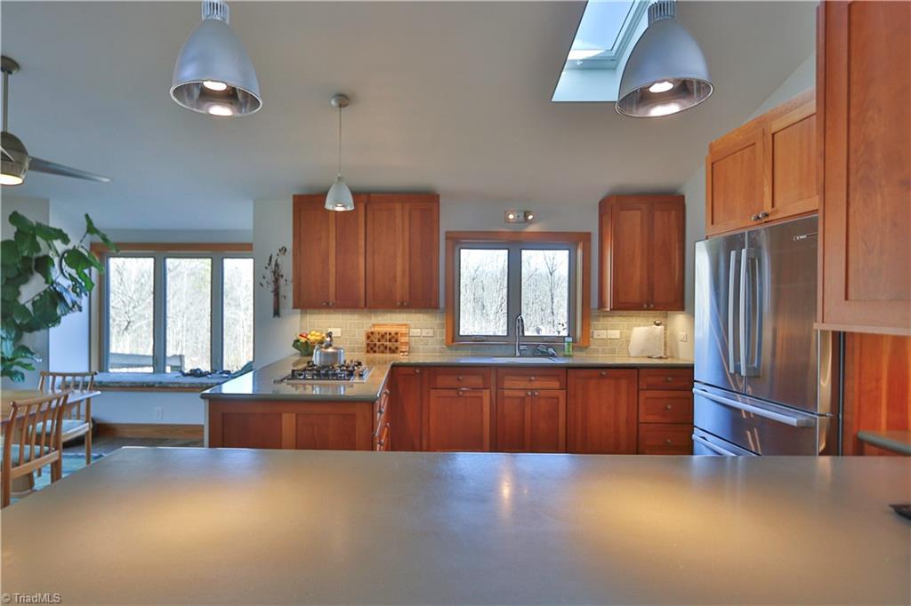 1045 West Old Phillips Road Pinnacle, NC 27043 - Photo 9 of 29 Wide counter opens to the living area with bar stools for entertaining friends and family.