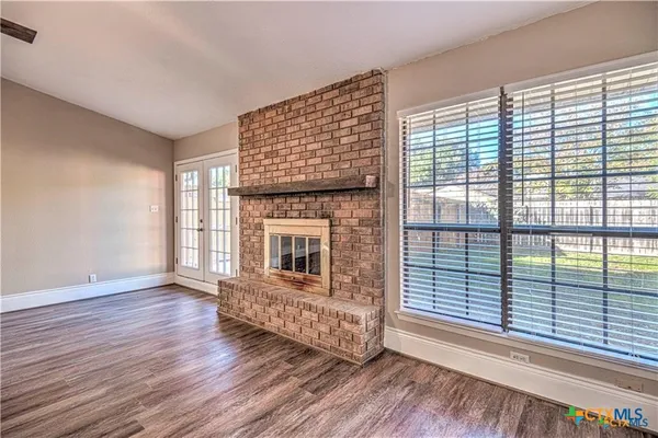 a living room with hardwood floor and a fireplace