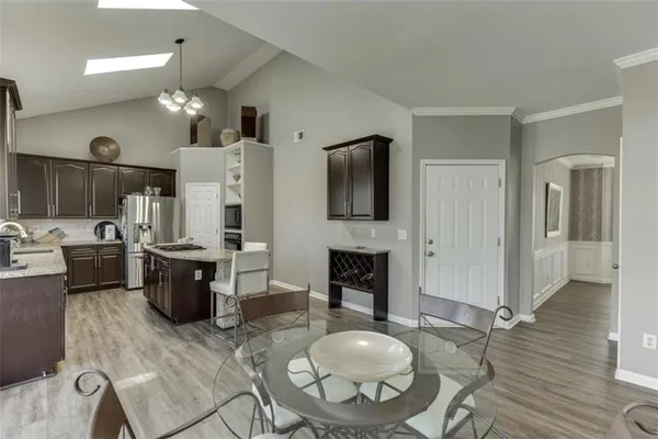 a kitchen with stainless steel appliances a sink stove and refrigerator