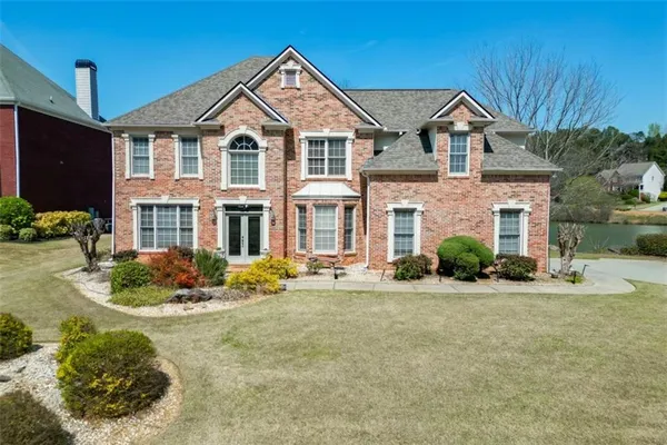 a front view of a house with a yard