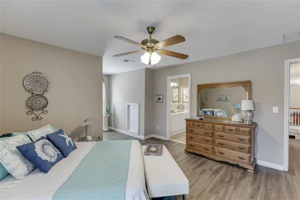a view of a hallway with wooden floor and windows