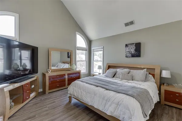 a bedroom with furniture and large window