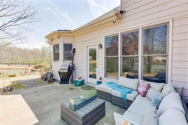 a view of a lake with table and chairs