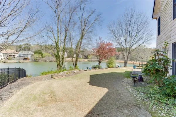 an aerial view of residential houses with outdoor space and river