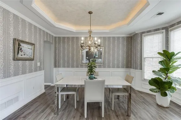 a view of a dining room with furniture and a chandelier
