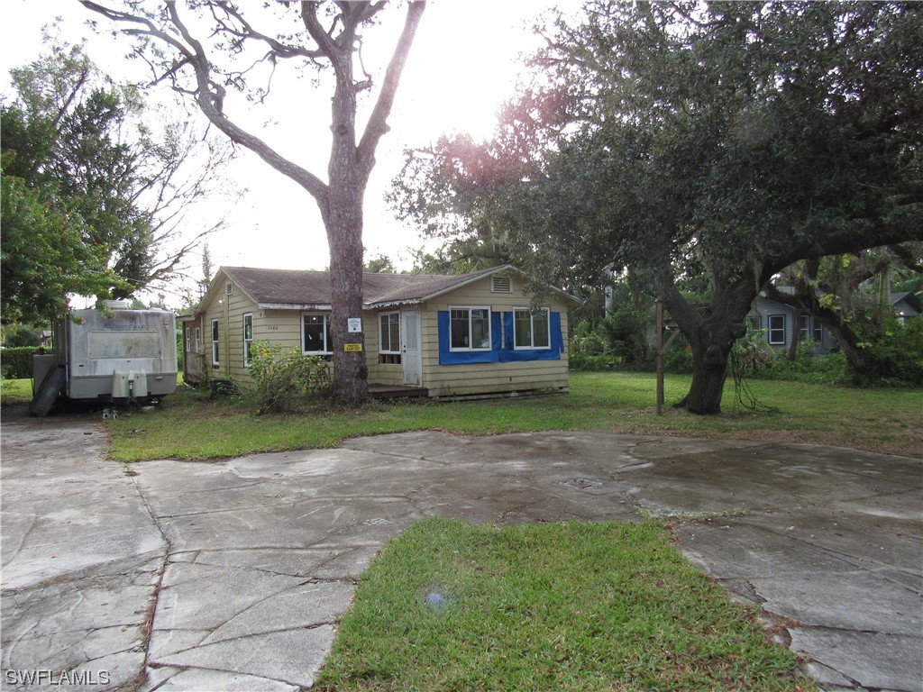 a view of an house with backyard space and garden