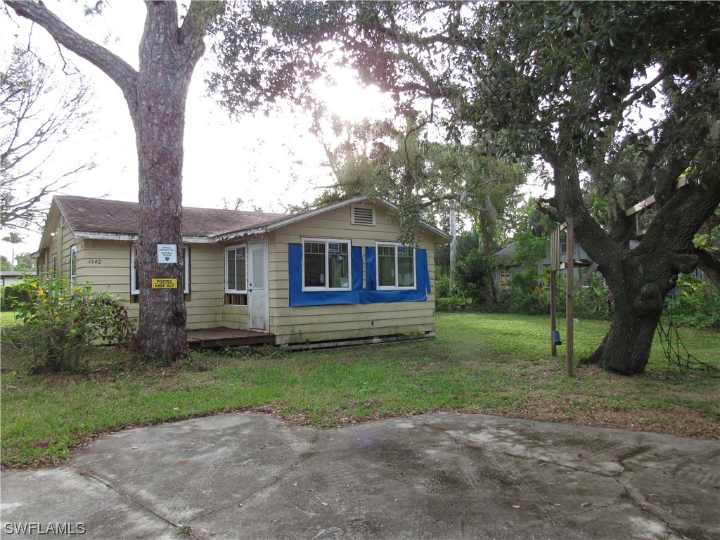 1140 River Road North Fort Myers, FL 33903 - Photo 2 of 17 a front view of a house with a garden
