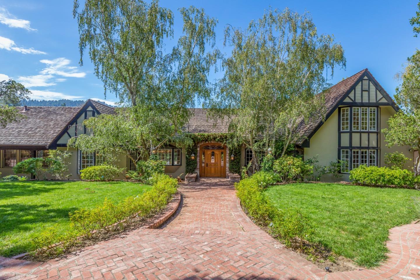 165 Farm Road Woodside, CA 94062 - Photo 2 of 29 a front view of a house with yard and green space