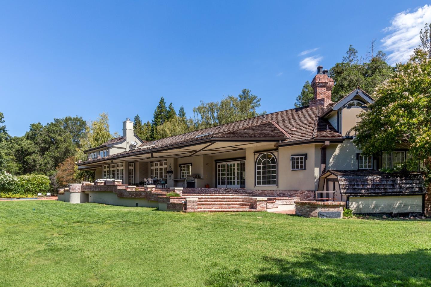 165 Farm Road Woodside, CA 94062 - Photo 21 of 29 a swimming pool view with a seating space and a garden