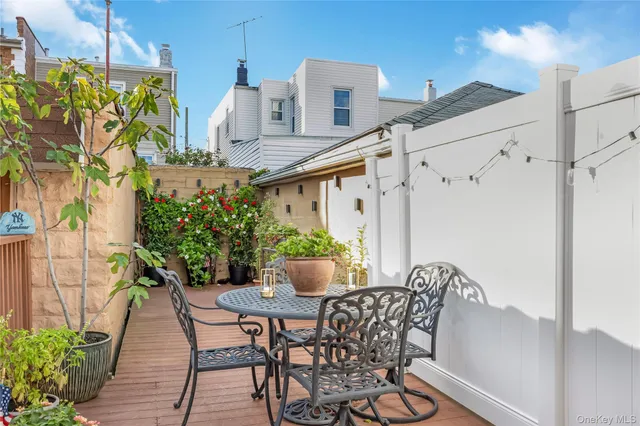 a view of a patio with table and chairs potted plants