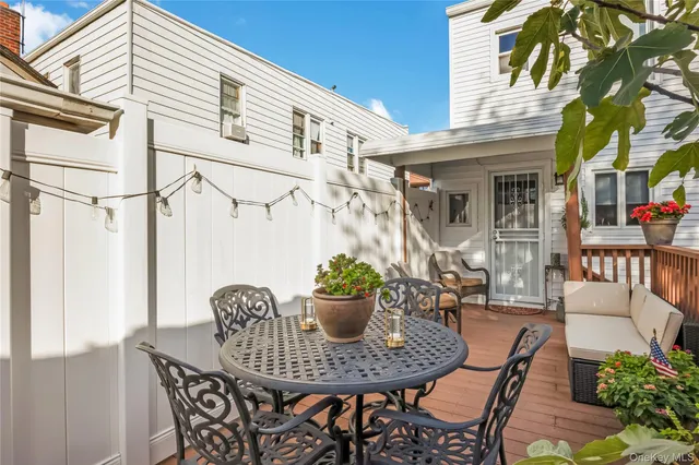 a view of a patio with table and chairs and potted plants