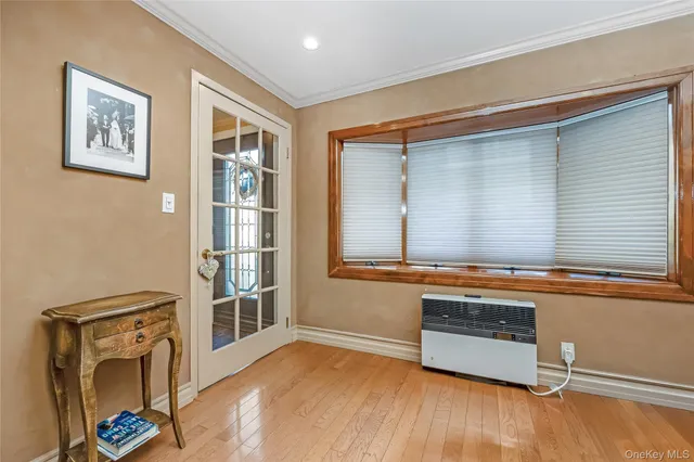 a view of a livingroom with wooden floor and a large window