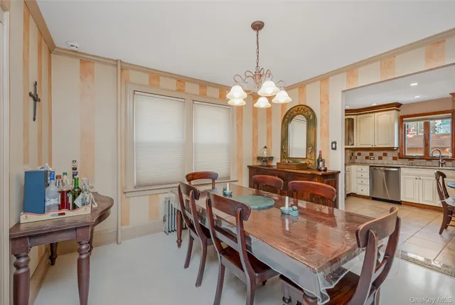 a view of a dining room with furniture and chandelier