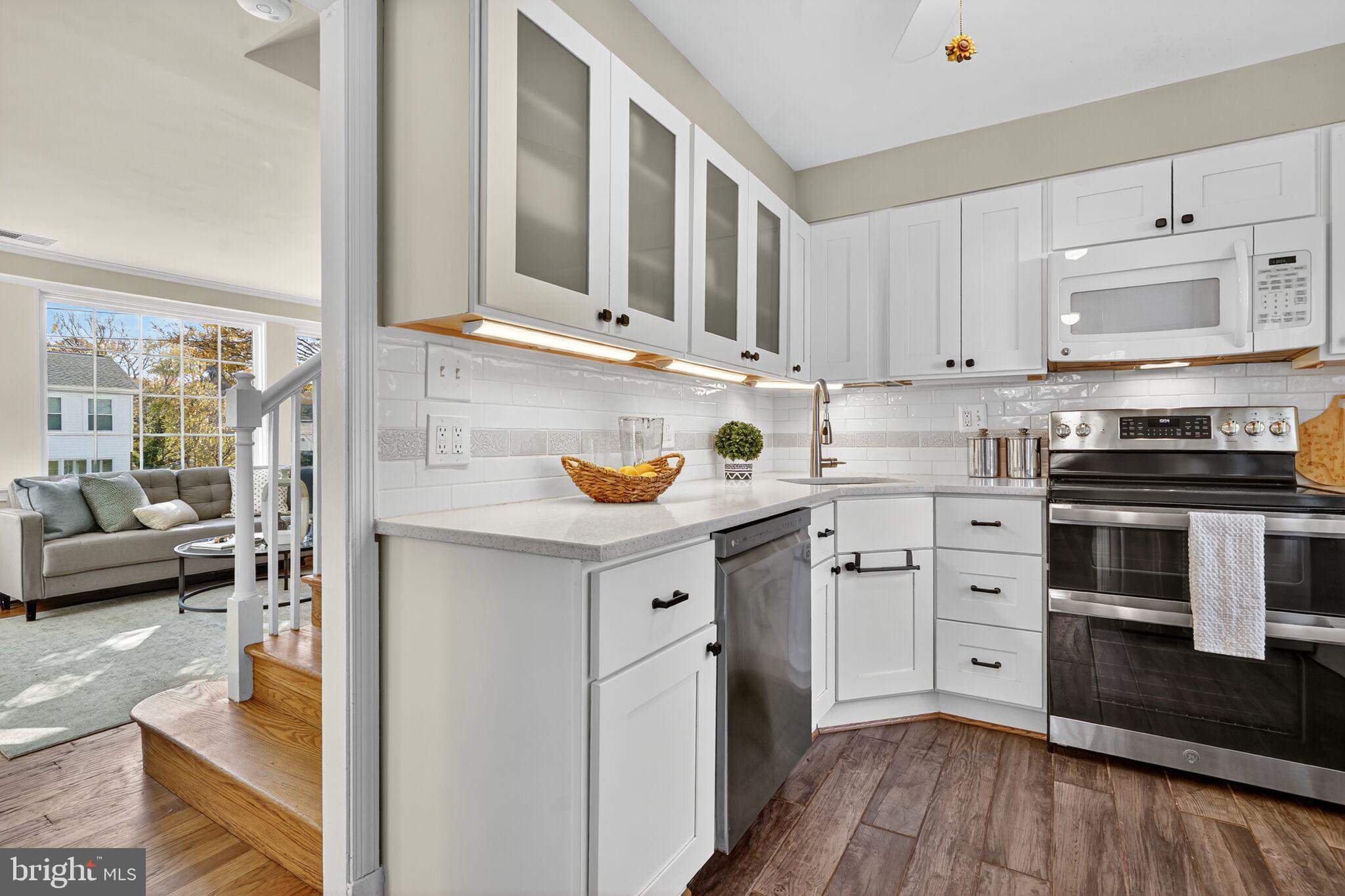315 Ladson Road Silver Spring, MD 20901 - Photo 12 of 26 a kitchen with stainless steel appliances granite countertop a stove and white cabinets