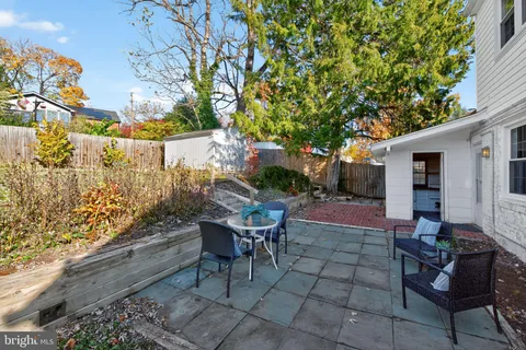 a backyard of a house with table and chairs