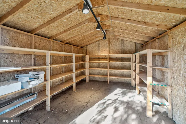 a view of an empty room with racks on the wall