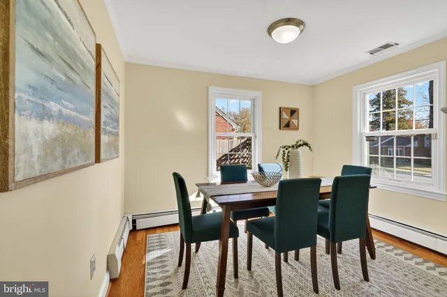 a view of a dining room with furniture and a window
