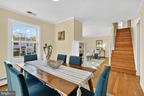 a dining room with furniture and wooden floor