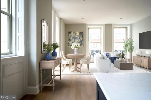 a living room with furniture a flat screen tv and a large window
