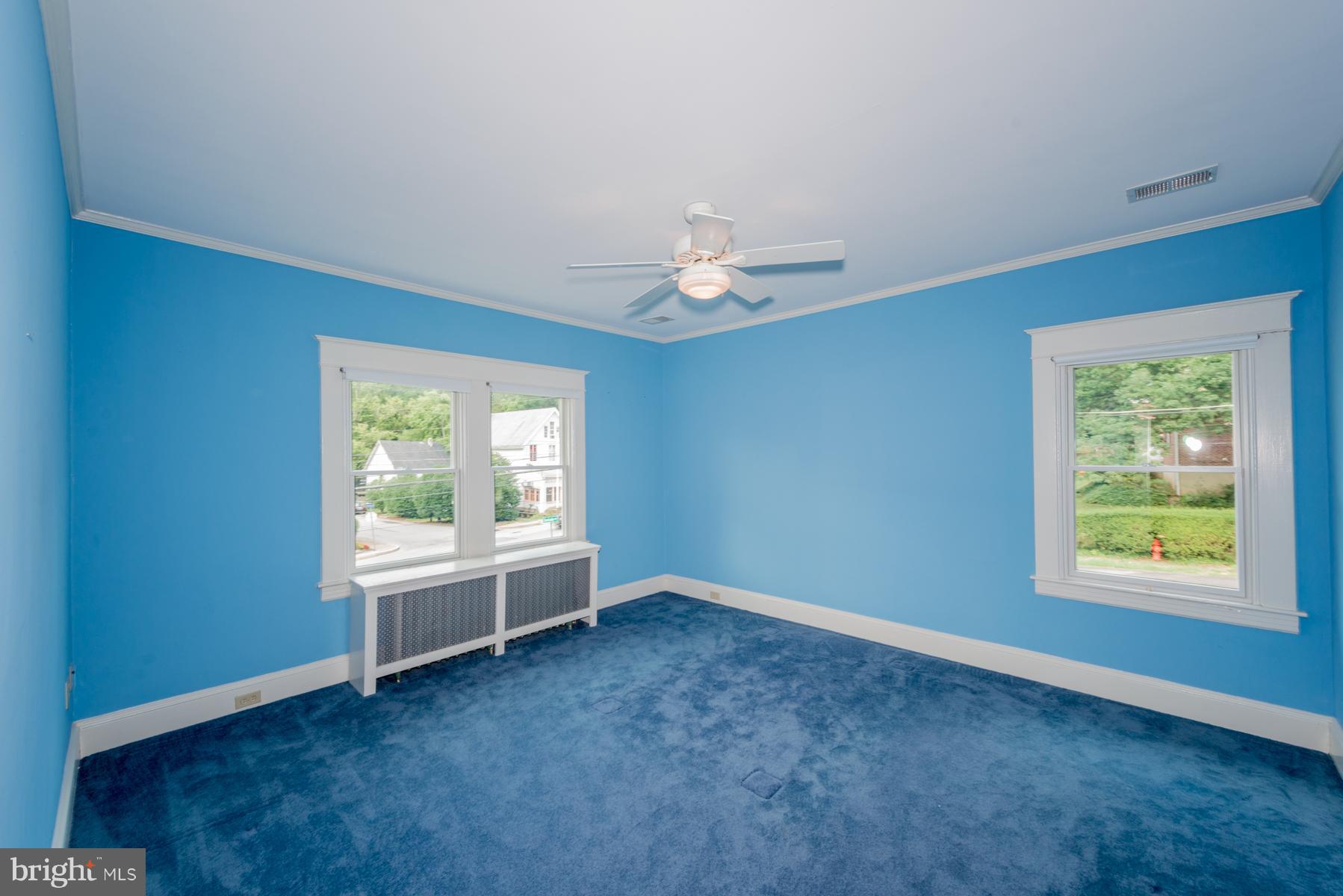 1701 Frederick Road Baltimore, MD 21228 - Photo 22 of 30 an empty room with windows and ceiling fan