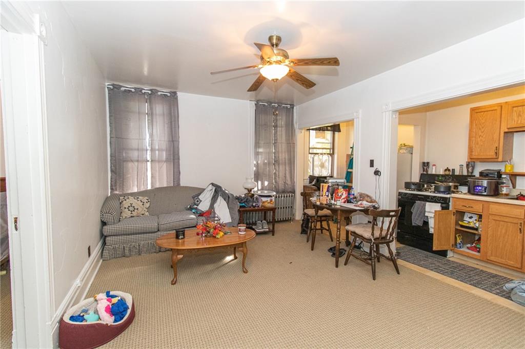 151 Margaret Street Pittsburgh, PA 15210 - Photo 23 of 36 a living room with furniture and a large window